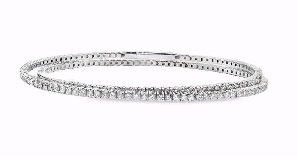 Elevate your style with this stunning flexible bangle. Crafted in 14kt white gold, this bangle showcases a continuous row of round cut diamonds that sparkle with every movement. With its brilliant cut and exceptional symmetry, this timeless piece is the perfect accessory for any occasion. Diamond weight-3.52ct