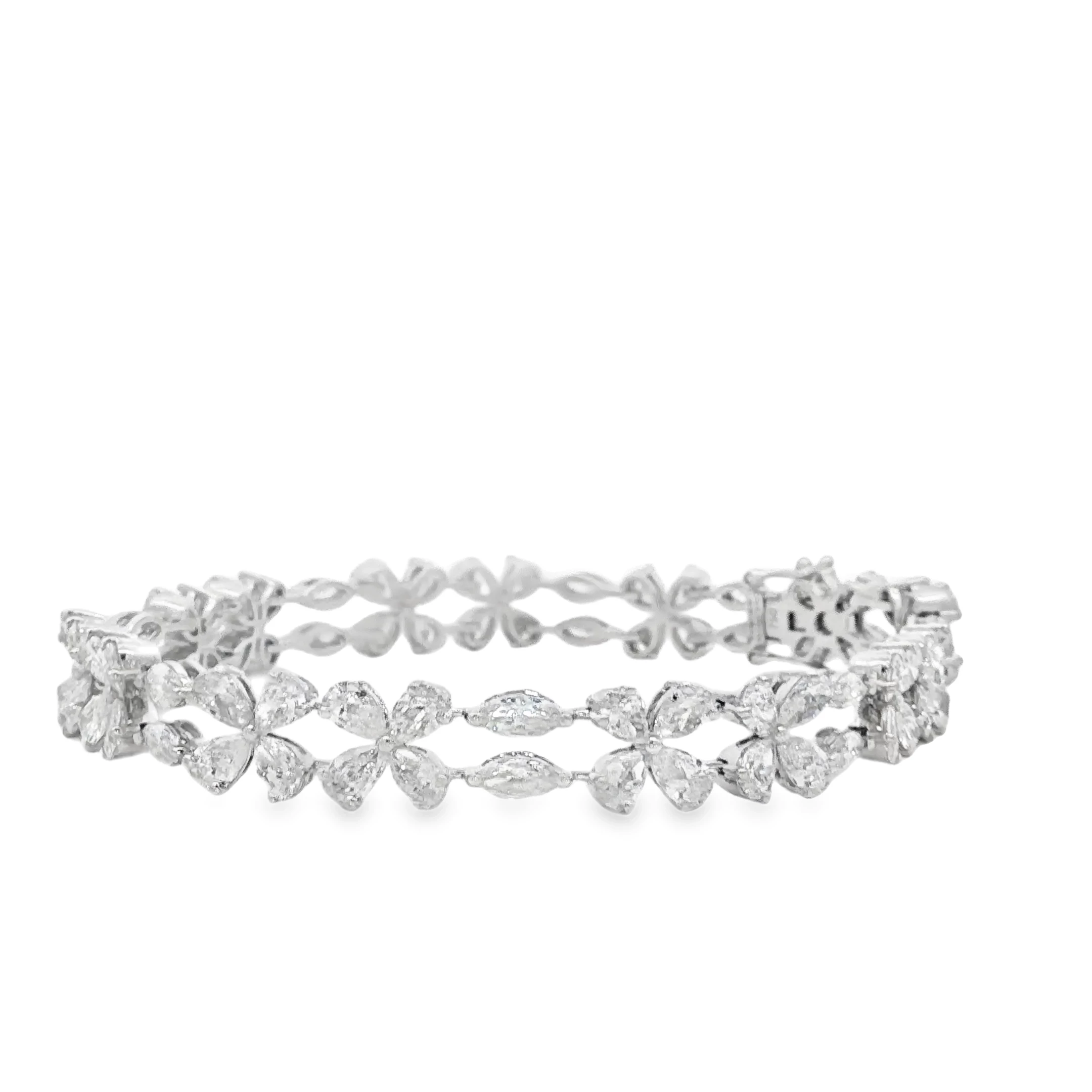 Indulge in the allure of this exquisite platinum tennis bracelet, featuring meticulously set pear cut diamonds. The brilliant cutting style enhances the inherent sparkle and fire of each diamond, creating a radiant display of light. This bracelet exemplifies timeless elegance and sophistication, perfect for adding a touch of luxury to any ensemble.