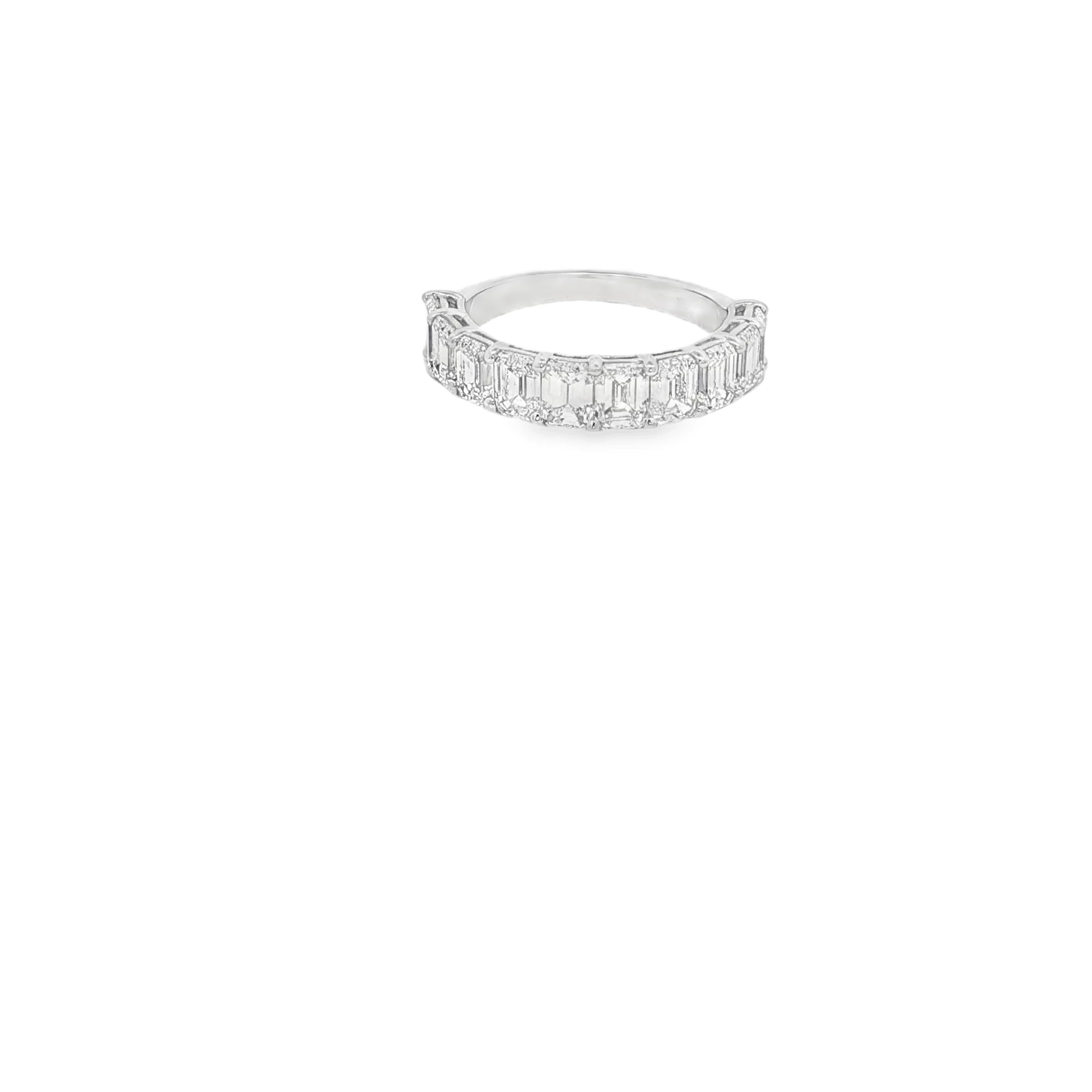 Elevate your style with this exquisite white gold eternity ring, featuring meticulously step-cut emerald diamonds. The ring's timeless design and brilliant sparkle make it a perfect symbol of everlasting love and commitment. Ideal for anniversaries or special occasions, this piece seamlessly blends classic elegance with modern sophistication.